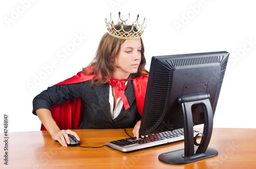 Photo: Superwoman worker with crown working in office Superwoman worker with crown working in office
