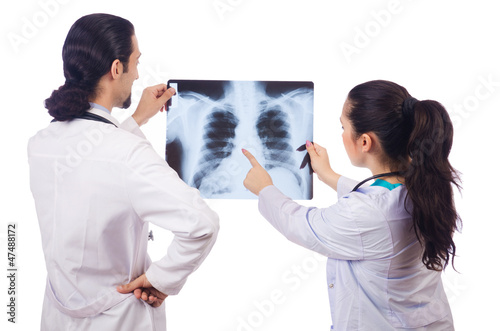 Photo: Two doctors looking at x-ray image on white Two doctors looking at x-ray image on white