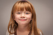 Fun Portrait of an Adorable Red Haired Girl on Grey