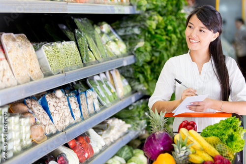 Photo: Woman shopping with a list Woman shopping with a list