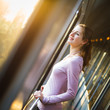 Young woman traveling by train, watching the  country side