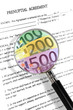 prenuptial agreement, magnifying glass and euro notes