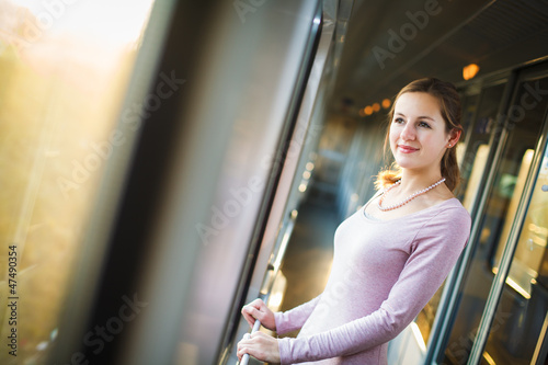 Photo: Young woman traveling by train, watching the country side Young woman traveling by train, watching the country side