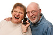Happy Senior Couple Using Cell Phone on White