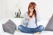 Photo: Beautiful Young Woman with Smartphone on the Sofa Beautiful Young Woman with Smartphone on the Sofa