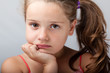 Sad girl on grey background