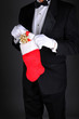 Photo: Man in Tux with Christmas Stocking Man in Tux with Christmas Stocking