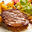 Grilled steak, baked potatoes and vegetables