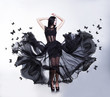 Sensual Woman in Black Fluttering Dress with Butterflies. Swing. Sensual Woman in Black Fluttering Dress with Butterflies. Swing.