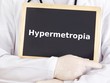 Doctor shows information on blackboard: hypermetropia
