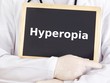 Doctor shows information on blackboard: hyperopia