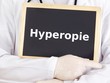 Doctor shows information on blackboard: hyperopia