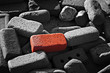 Single red brick amongst lots of monochrome bricks