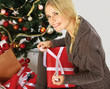 Photo: Girl sitting near christmas tree and packing gifts Girl sitting near christmas tree and packing gifts