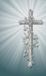 cross with ornaments on a greyish background and shine