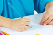 Children's hand draw with colored pencils close up