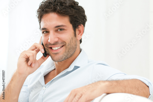 Photo: Young Man Talking On Cell Phone Young Man Talking On Cell Phone