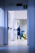 Women at workplace, professional female cleaner washing floor in