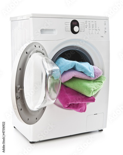 Photo: Washing machine with laundry isolated on white Washing machine with laundry isolated on white