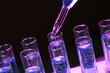 test-tubes with liquid on black background