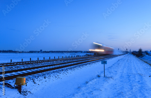 Photo: Train speeding in winter. Train speeding in winter.