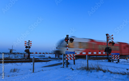 Photo: Train @ railroad crossing in winter Train @ railroad crossing in winter