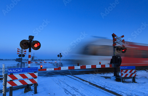 Photo: Train and railroad crossing in winter Train and railroad crossing in winter