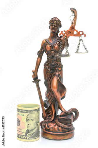Photo: statue of justice and money on a white background statue of justice and money on a white background
