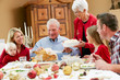 Multi Generation Family Celebrating With Christmas Meal