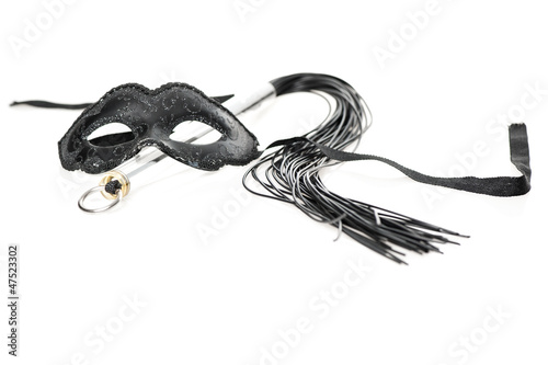 Photo: Black mask and whip on white background Black mask and whip on white background