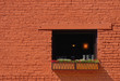 Light in Window in Brick Building