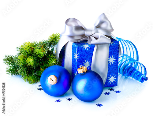 Photo: Christmas Gift Box and Decorations isolated on White Background Christmas Gift Box and Decorations isolated on White Background