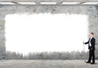 Business person standing near a blank billboard