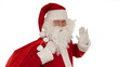 Santa Claus carrying his bag, sends a kiss and wave