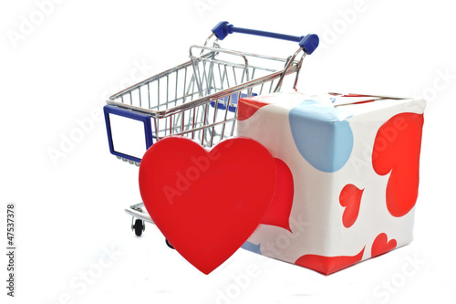 Photo: Shopping cart full of chocolate candy and big red heart Shopping cart full of chocolate candy and big red heart