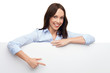 Businesswoman pointing at blank poster