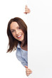 Woman peeping over blank poster