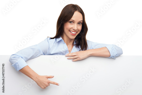 Photo: Businesswoman pointing at blank poster Businesswoman pointing at blank poster