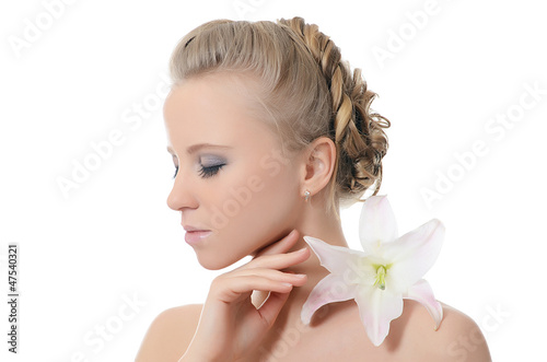 Photo: The beautiful blonde woman with lily flower The beautiful blonde woman with lily flower