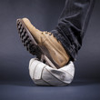Mens foot stepped on the old leather ball