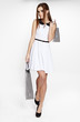 Shopping woman holding bags, isolated on gray studio background.