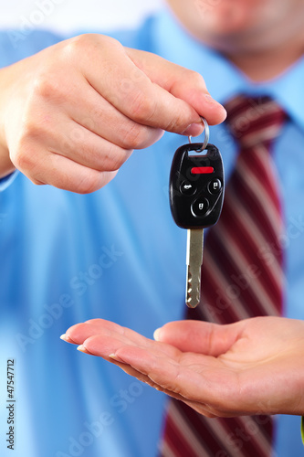 Photo: Hand with a car key. Hand with a car key.