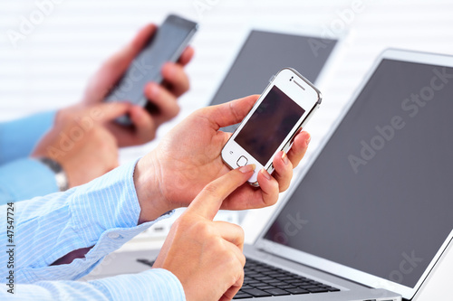 Photo: Business people calling by smartphone. Business people calling by smartphone.