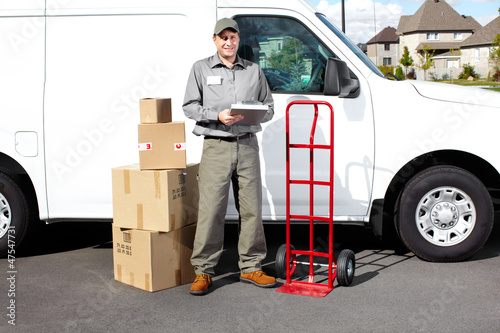Photo: Smiling delivery courier. Smiling delivery courier.