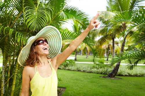 Photo: Woman in the tropical garden. Woman in the tropical garden.