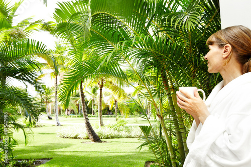 Photo: Woman in the tropical garden. Woman in the tropical garden.