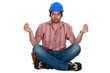 Builder sitting in yoga position