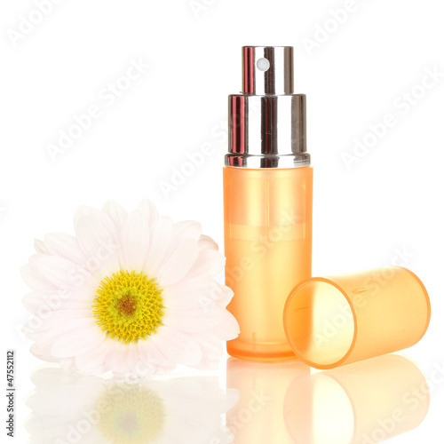 Photo: Women's perfume in beautiful bottle with flower isolated Women's perfume in beautiful bottle with flower isolated