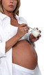 Pregnant woman eating yogurt