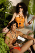 Photo: young couple with animal in tropical green forest background young couple with animal in tropical green forest background